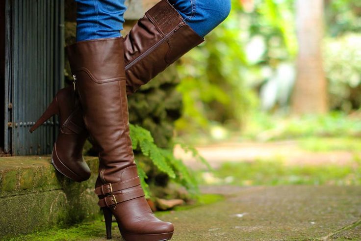 Bota marrom de couro com salto alto em ambiente natural