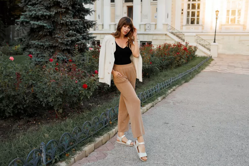 Mulher elegante em jardim com flores ao fundo